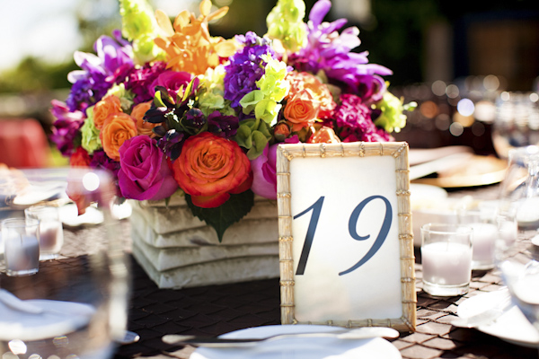 bouquet of flowers as centerpieces next to table numbers - wedding photo by top Orange County, California wedding photographers D. Park Photography